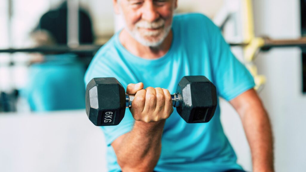 senior working his upper body with a dumbell seated